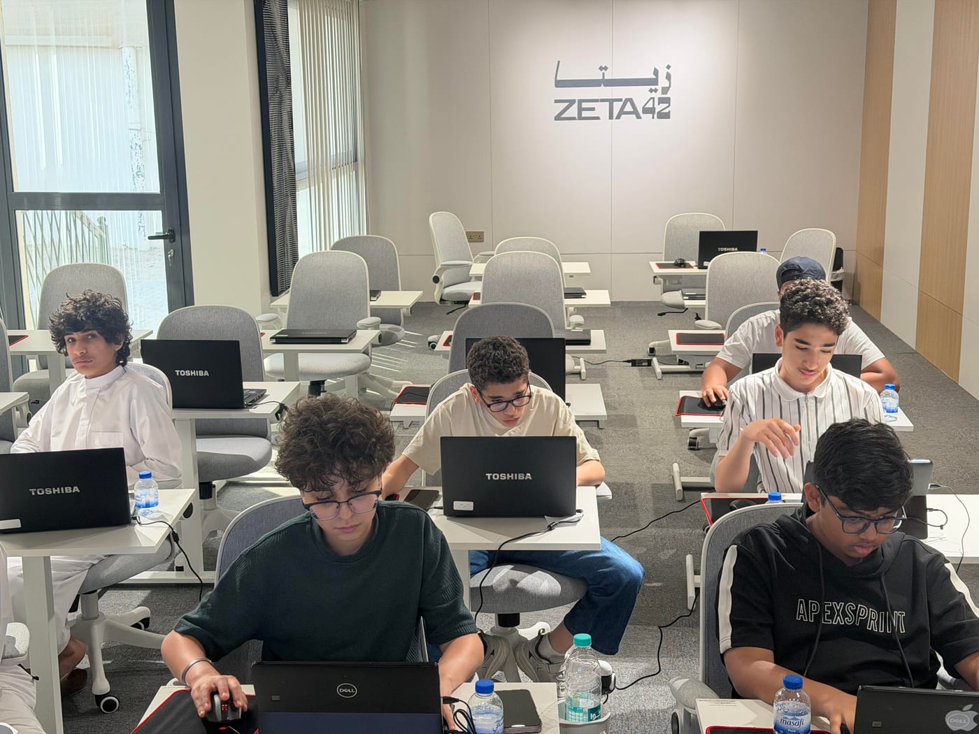 An instructor supporting students in a corporate session